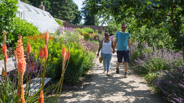 Visitors walking in the upper garden at Quarry Bank, Cheshire